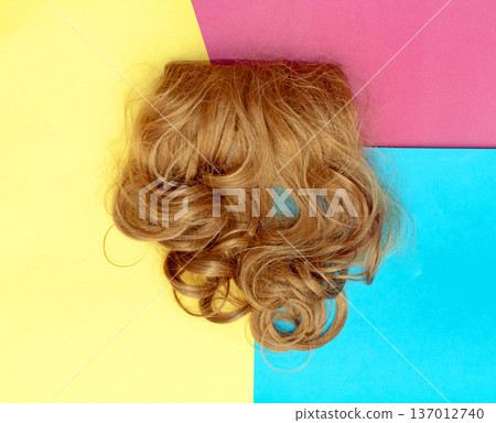 Big curls hair wig on colorful background Big curls hair wig on colorful background 137012740