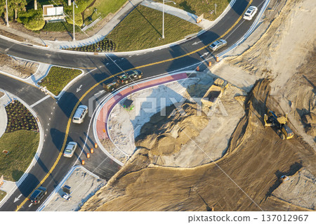 Aerial view of busy American highway road under construction. Development of roundabout traffic infrastructure. State transportation concept Aerial view of busy American highway road under construction. Development of roundabout traffic infrastructure. State transportation concept 137012967