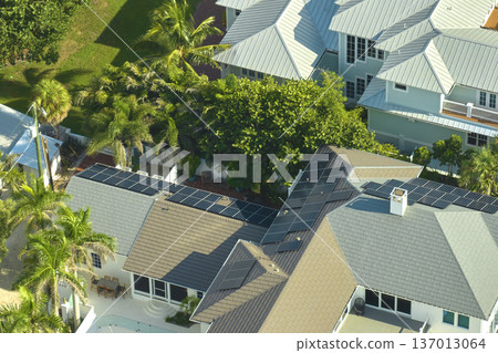 Aerial view of new expensive american building roof with rows of blue solar photovoltaic panels for producing clean ecological electric energy. Renewable electricity with zero emission concept 137013064