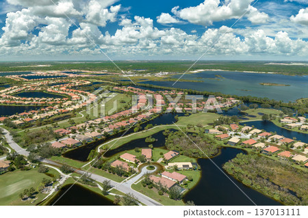 Consequences of natural disaster. Heavy flood with high water surrounding residential houses after hurricane Ian rainfall in Florida residential area 137013111