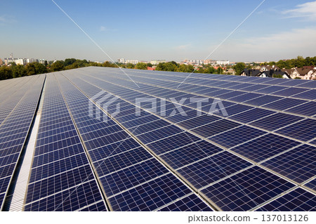 Photovoltaic panels on solar rooftops of commercial building for producing clean ecological electrical energy. Renewable electricity with zero emission concept 137013126