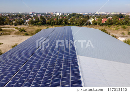 Solar photovoltaic panels installed on building roof for producing clean ecological electric energy. Renewable electricity with zero emission concept 137013130