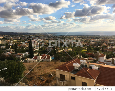 Coastal town with sea horizon in Cyprus. Evening atmosphere, travel inspiration and urban landscape panorama concept Coastal town with sea horizon in Cyprus. Evening atmosphere, travel inspiration and urban landscape panorama concept 137013305