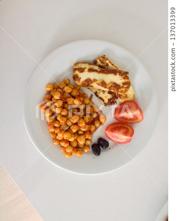Plate with chickpea and grilled cheese and tomato. Mediterranean cuisine, healthy eating, protein source and balanced nutrition Plate with chickpea and grilled cheese and tomato. Mediterranean cuisine, healthy eating, protein source and balanced nutrition 137013399