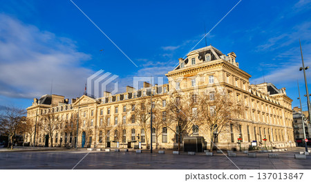 Scenic sunny view of the historic classical stone facade of the Caserne Verines building at the Place de la Republique square in Paris, France. Scenic sunny view of the historic classical stone facade of the Caserne Verines building at the Place de la Republique square in Paris, France. 137013847
