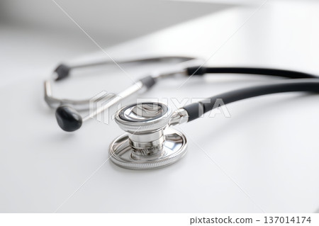 A closeup image displaying a stethoscope resting elegantly on a clean, polished surface 137014174