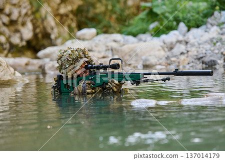 Camouflaged Sniper Soldier In Water With Scoped Rifle And Suppressor During Reconnaissance Operation 137014179