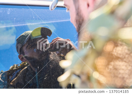 Soldier Shaving Beard Using Vehicle Window Reflection While Wearing Camo Cap And Tactical Gear 137014185