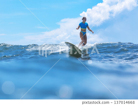 Selfassured Female Athlete Displays Mastery Over Ocean Waves During Summer Selfassured Female Athlete Displays Mastery Over Ocean Waves During Summer 137014668