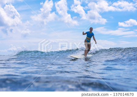 Female Surfer Merging Mindfulness With Sea Calmness And Breezes 137014670
