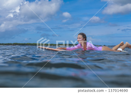 Woman Practicing Accurate Surfing Skills In Peaceful Seaside Environment Woman Practicing Accurate Surfing Skills In Peaceful Seaside Environment 137014690