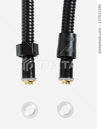Black shower hose is insulated on a white background. Close-up. 137015395