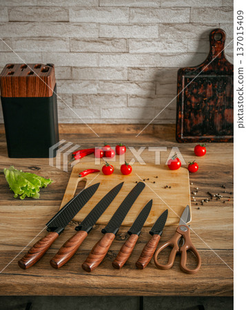 Beautiful set of knives on the background of the kitchen. Beautiful set of knives on the background of the kitchen. 137015409