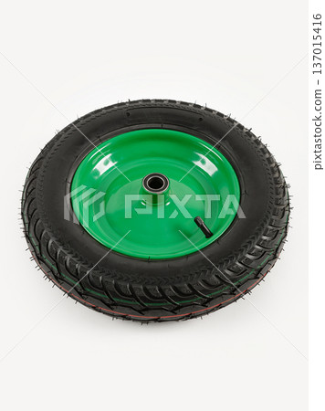 Wheel is pneumatic on a white background. Black rubber, green disc. Wheel is pneumatic on a white background. Black rubber, green disc. 137015416