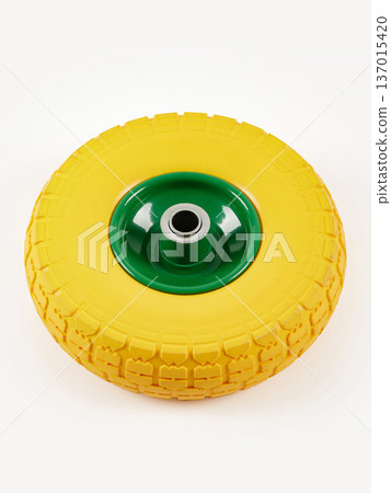 Wheel is pneumatic on a white background. Yellow rubber, green disc. 137015420