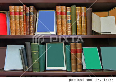 Old books on wooden shelves 137015437