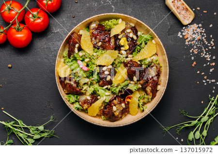 Gourmet chicken salad with orange slices and pine nuts healthy restaurant bowl Gourmet chicken salad with orange slices and pine nuts healthy restaurant bowl 137015972