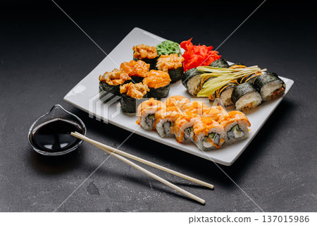 Assorted sushi set with rolls nigiri shrimp and soy sauce on restaurant plate Assorted sushi set with rolls nigiri shrimp and soy sauce on restaurant plate 137015986
