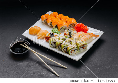 Assorted sushi set with rolls nigiri shrimp and soy sauce on restaurant plate Assorted sushi set with rolls nigiri shrimp and soy sauce on restaurant plate 137015995