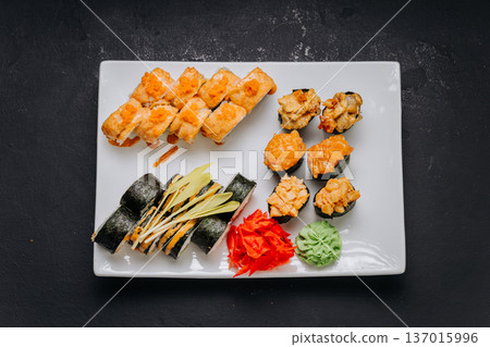 Assorted sushi set with rolls nigiri shrimp and soy sauce on restaurant plate Assorted sushi set with rolls nigiri shrimp and soy sauce on restaurant plate 137015996