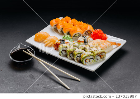 Assorted sushi set with rolls nigiri shrimp and soy sauce on restaurant plate 137015997