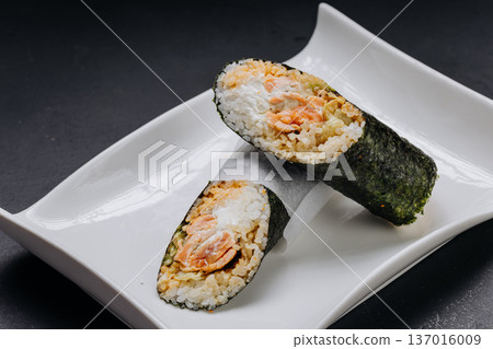 Japanese temaki sushi hand roll with salmon rice and cream cheese on white plate Japanese temaki sushi hand roll with salmon rice and cream cheese on white plate 137016009