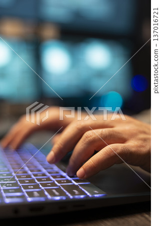 Closeup of hands typing on laptop during software programming tasks at office. Caucasian developer programs on digital device, enhancing functions and strengthening company data protection. Closeup of hands typing on laptop during software programming tasks at office. Caucasian developer programs on digital device, enhancing functions and strengthening company data protection. 137016721