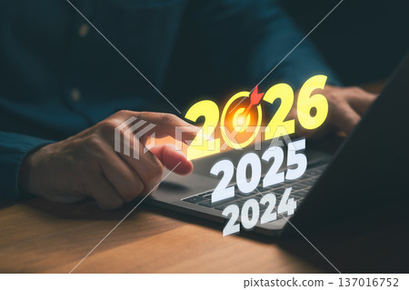 Person selecting the year 2026 on a laptop, symbolizing future planning, business goals, long-term strategy, digital forecasting, and upcoming vision for organizational development. Person selecting the year 2026 on a laptop, symbolizing future planning, business goals, long-term strategy, digital forecasting, and upcoming vision for organizational development. 137016752