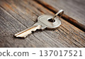 Silver Key on Rustic Wooden Table Close-up 137017521