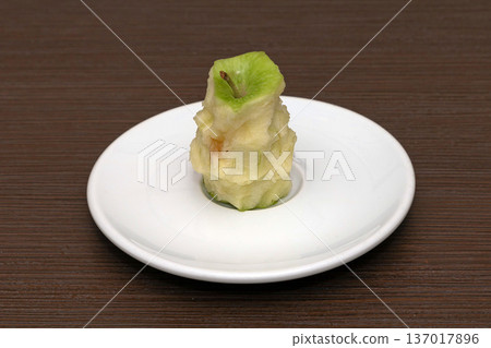 Bitten apple on a plate Bitten apple on a plate 137017896