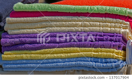 Stack of colorful towels on market 137017904