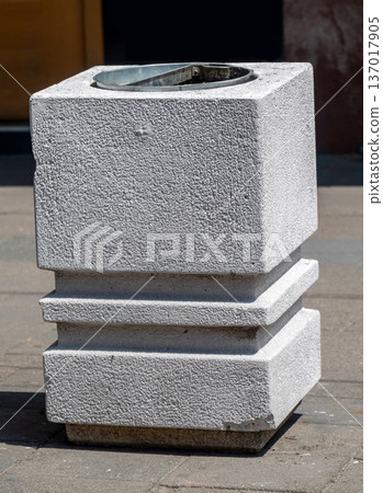 Stone trash bin on street pavement Stone trash bin on street pavement 137017905