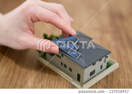 Image of installing solar panels on a house 137018457