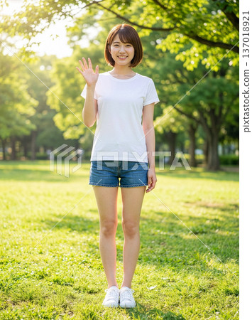 Portrait of a young woman standing in a park 137018921