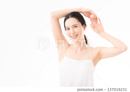 Beauty image of a woman doing skin care on a white background 137019231