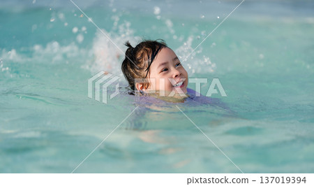 preschool child girl playing and swimming in pool preschool child girl playing and swimming in pool 137019394