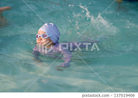 preschool child girl playing and swimming in pool preschool child girl playing and swimming in pool 137019406