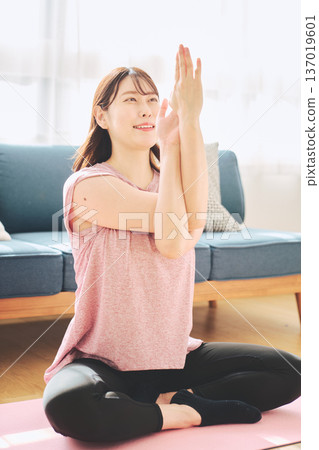 Healthy habits of a woman in her 30s stretching at home 137019601