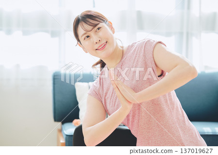 Fitness life of a woman in her 30s doing yoga poses in her living room 137019627