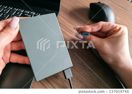 External hard drive for storing large amounts of information. Additional electronic data storage device. High quality photo External hard drive for storing large amounts of information. Additional electronic data storage device. High quality photo 137019748