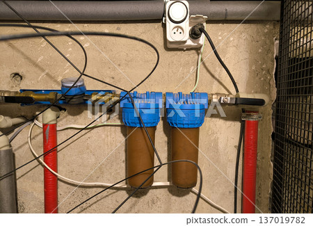 Water purification filters for plumbing pipes in a private house. High quality photo Water purification filters for plumbing pipes in a private house. High quality photo 137019782