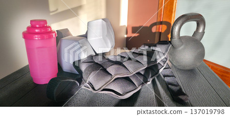 Foot and forearm weights, dumbbells and a water bottle for sports. Exercise weights. Sports accessories. Healthy lifestyle. High quality photo Foot and forearm weights, dumbbells and a water bottle for sports. Exercise weights. Sports accessories. Healthy lifestyle. High quality photo 137019798