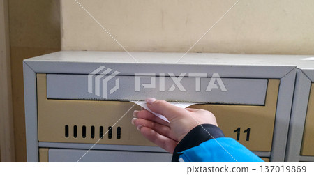 A paper notice in a mailbox. Mailbox in an apartment building. High quality photo 137019869