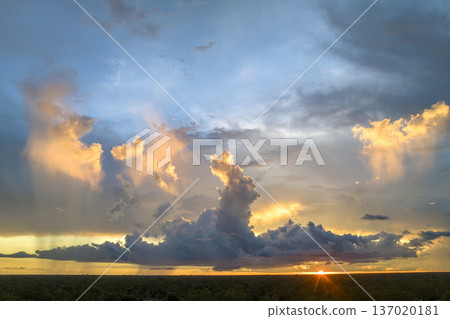Cumulonimbus clouds forming before thunderstorm on evening sky. Changing stormy cloudscape weather at sunset Cumulonimbus clouds forming before thunderstorm on evening sky. Changing stormy cloudscape weather at sunset 137020181