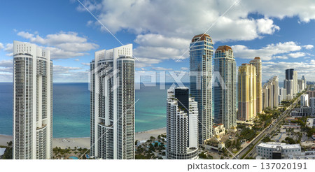 Expensive highrise hotels and condos on Atlantic ocean shore in Sunny Isles Beach city. American tourism infrastructure in southern Florida 137020191