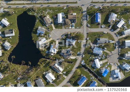 Aftermath of natural disaster in southern Florida. Badly damaged mobile homes after hurricane Ian swept through residential area Aftermath of natural disaster in southern Florida. Badly damaged mobile homes after hurricane Ian swept through residential area 137020368