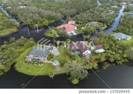 Consequences of natural disaster. Heavy flood with high water surrounding residential houses after hurricane Ian rainfall in Florida residential area Consequences of natural disaster. Heavy flood with high water surrounding residential houses after hurricane Ian rainfall in Florida residential area 137020435