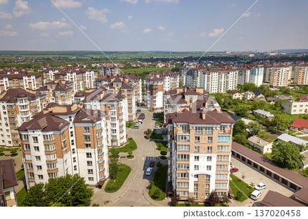 Top view of apartment or office tall buildings, parked cars, urban city landscape. Drone aerial photography. Top view of apartment or office tall buildings, parked cars, urban city landscape. Drone aerial photography. 137020458
