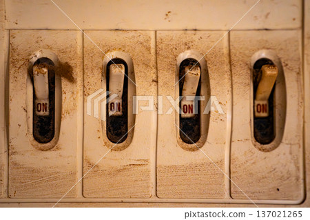 Four breaker switches lined up horizontally 137021265