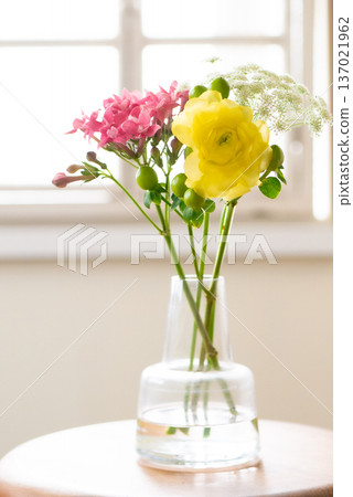 Colorful mini bouquets in a vase on a windowsill [Spring] 137021962